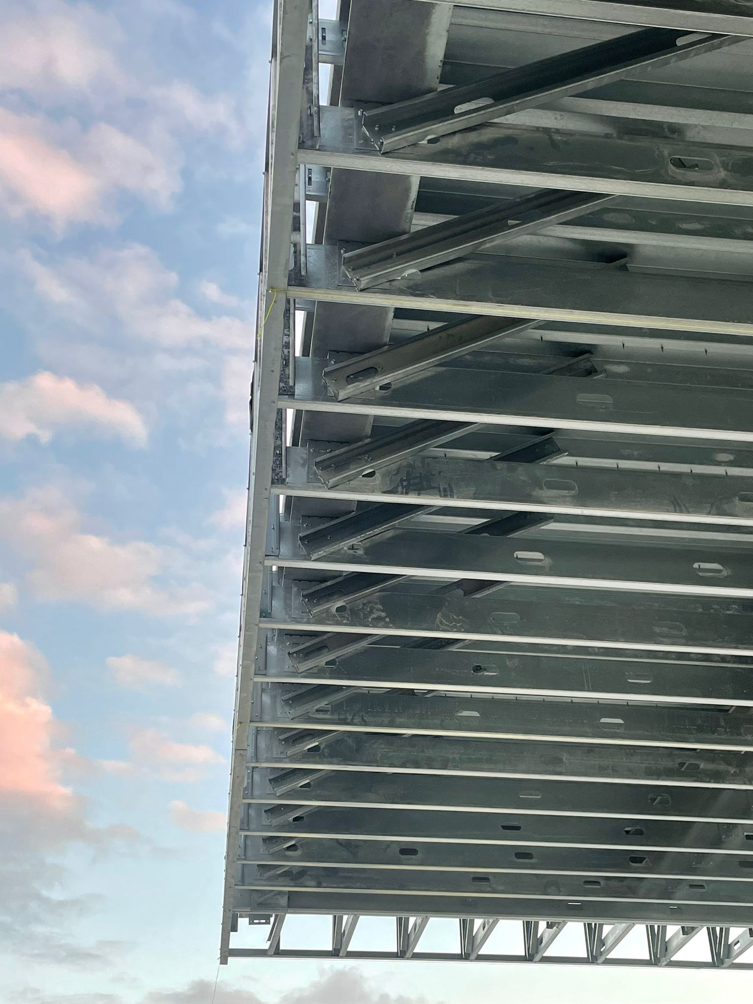 Steel stud soffit framing detail against sunset sky